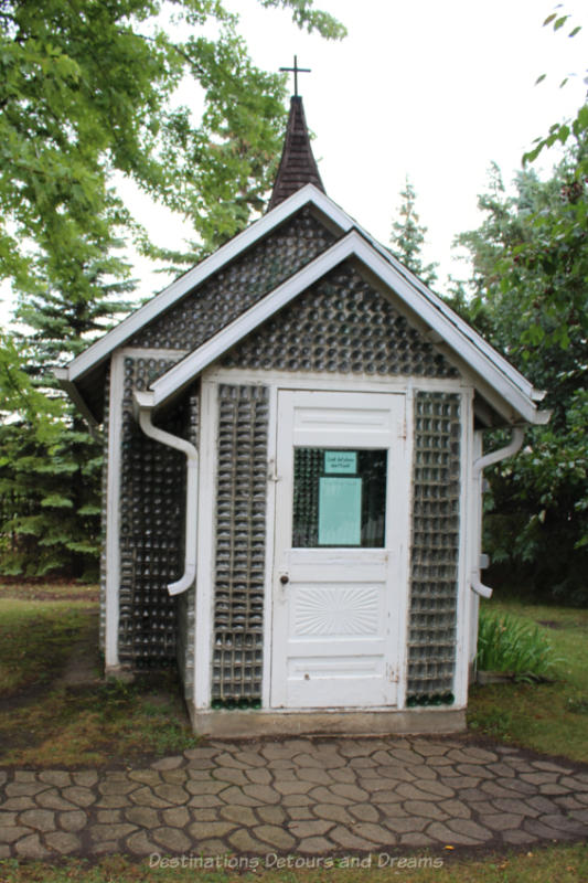 Front of a small church built from glass bottles