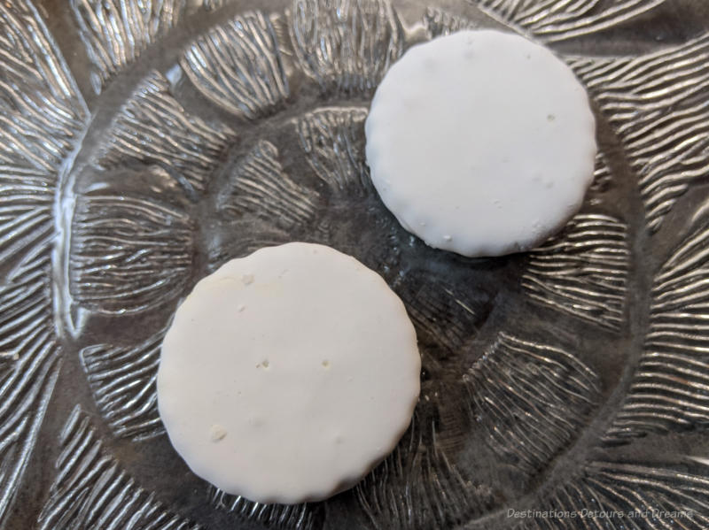 Winnipeg Food Imperial Cookie Two white iced Imperial cookies on a clear glass plate
