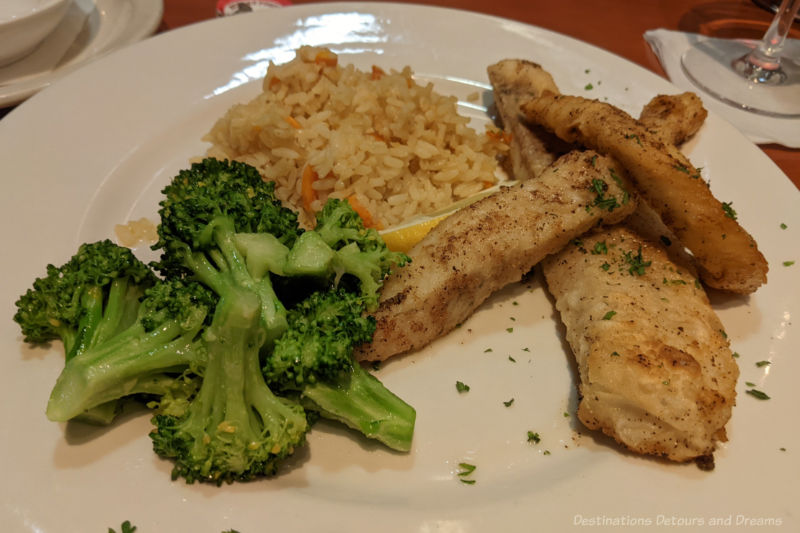 Winnipeg Food Pickerel Dinner A dinner plate containing lightly seasoned pan-fried pickerel (walleye), rice pilaf, and broccoli