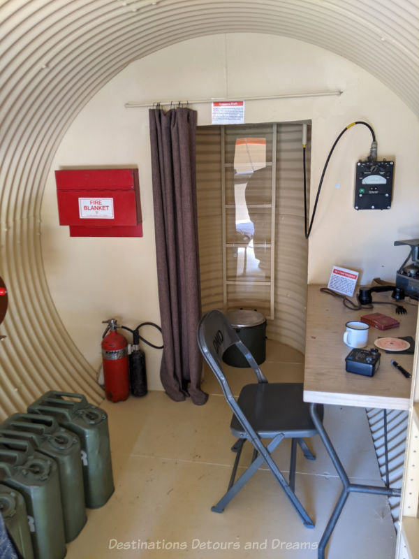 Miami Railway Station Museum Bunker Interior Inside of an underground metal bunker shows desk and circular area at back with ladder entrance/exit