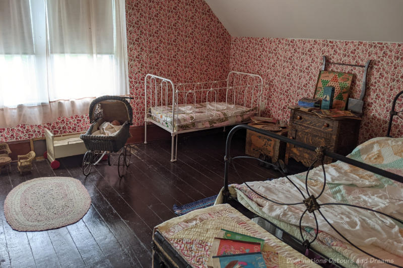 Miami Railway Station Museum Children Bedroom Museum room decorated as an early 1900s children's bedroom with two beds, dress, children's books and toys