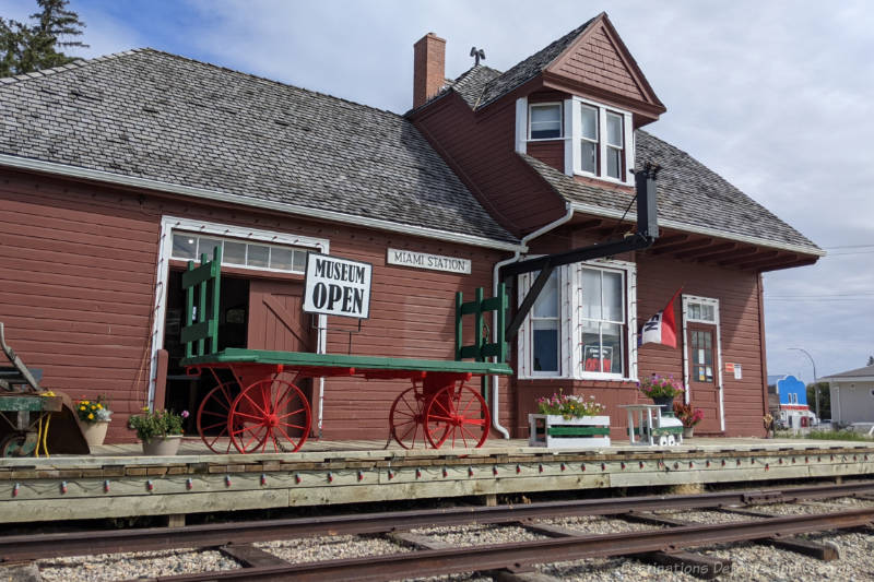 Miami Railway Station Museum Reddish-brown wood sided railway station building turned museum beside railway tracks