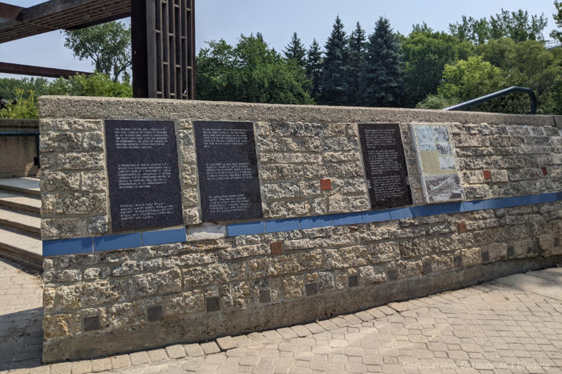 The Forks Turtle Tours Wall Through Time Stone half-wall along a brick pathway contains panels of information