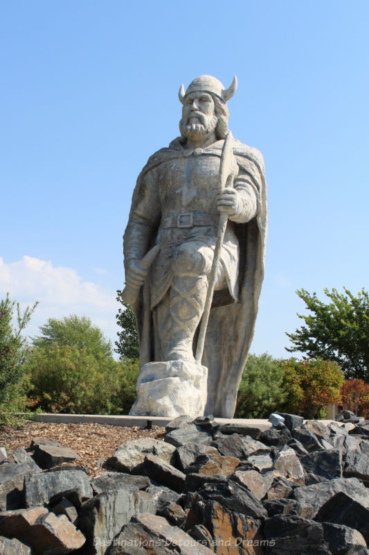Gimli Viking Statue Large fibreglass Viking statue with horned hate, one knee bent, and holding an ax