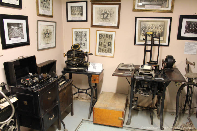 Daly House Museum Basement Display Museum display of old machines and vintage photographs on the wall