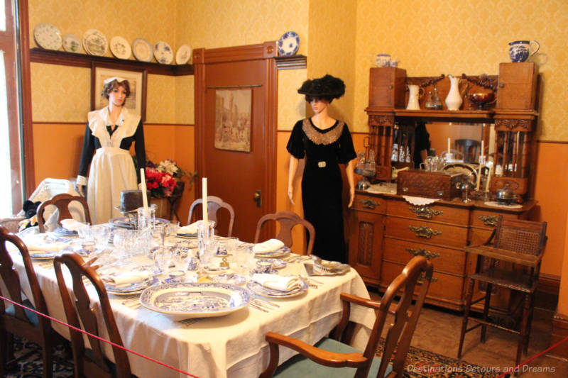 Daly House Museum Dining Room Victorian-era dining room in a house museum with table set with blue and white china