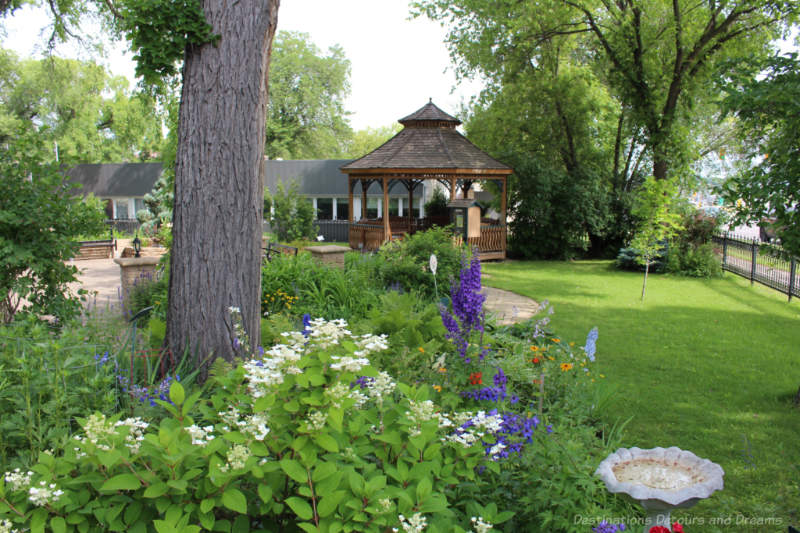 Daly House Museum Garden Garden area with lawn, flowers, and gazebo at back