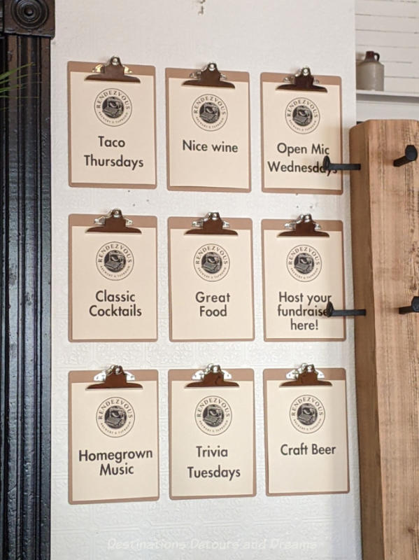 Rendezvous Events Clipboards hanging on a white wall contain names of regular events at a taproom and eatery