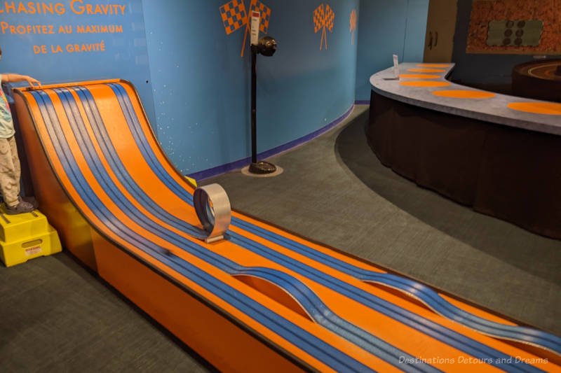 Orange and blue toy car race track uses gravity to propel toy cars