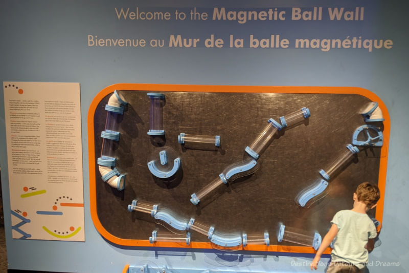 Magnetic wall in science museum to arrange tubes of various shapes and sizes and drop balls through