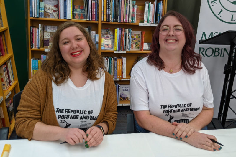 Portage & Main Signing Alex Judge and Sabrina Janke behind a table ready to sign their books