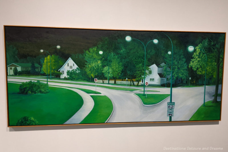 Staycation View from the Bridge Painting of a residential street leading off an intersections with green expanses of lawn and white houses