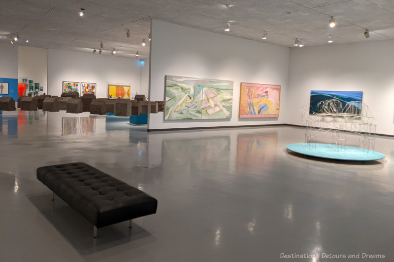 Art gallery white white walls featuring a variety of paintings