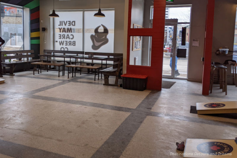Devil May Care Cornhole Area within a taproom cleared for a cornhole tournament