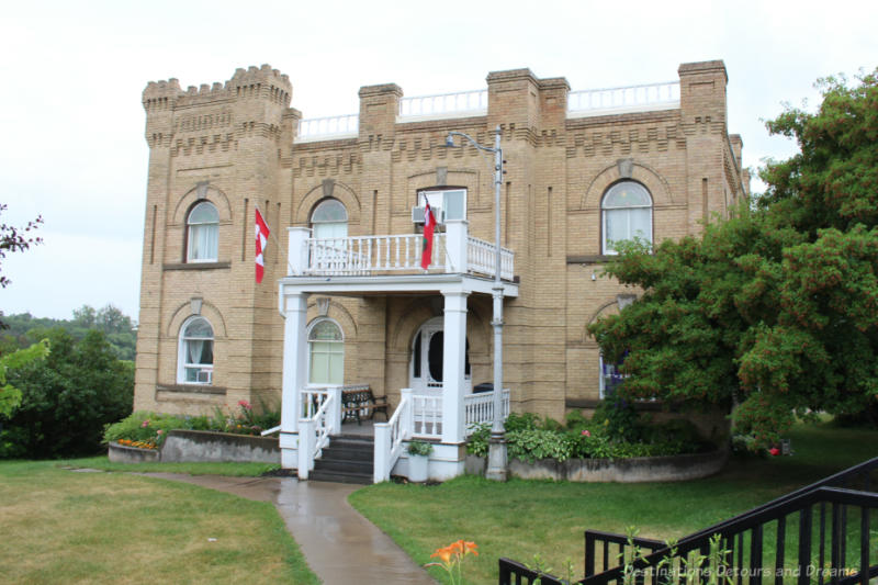 Hillcrest Museum - Large brick two story house with crenellated towers double-height wooden porches