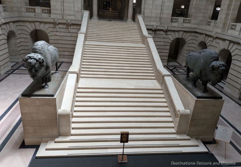 Grand marble staircase flanked by life-sized bronze bison statues
