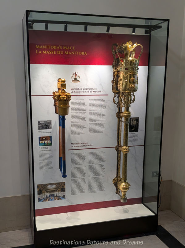 Display case containing two government maces