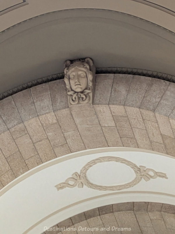 Carving of Medusa set into archway of a building