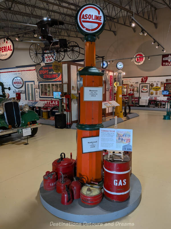 Museum room contain vintage gas pumps and vehicles