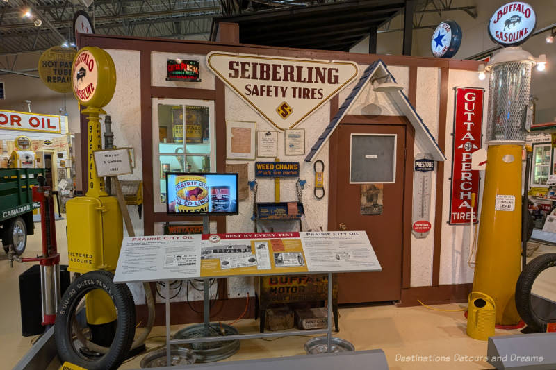 Museum display featuring vintage gas pumps, and garage signs
