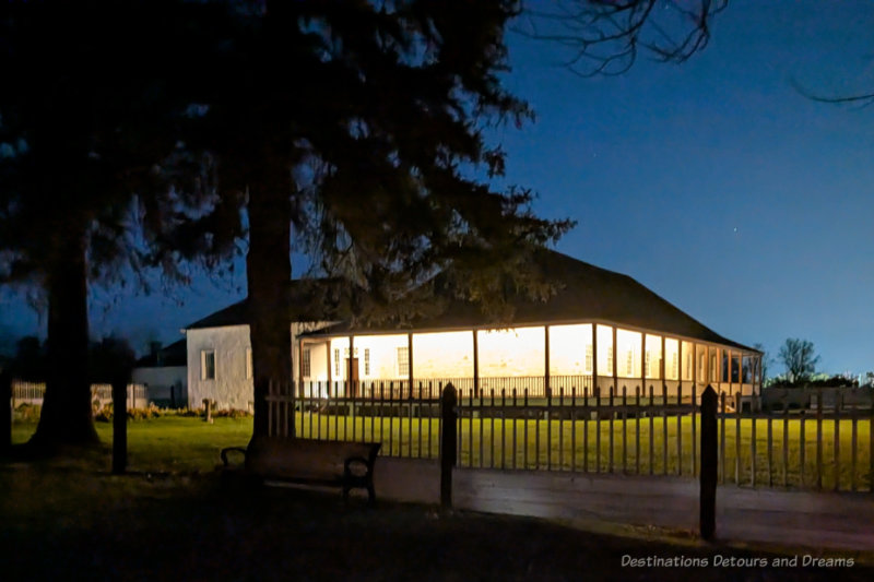 Stone big house inside a fort lit along veranda at night